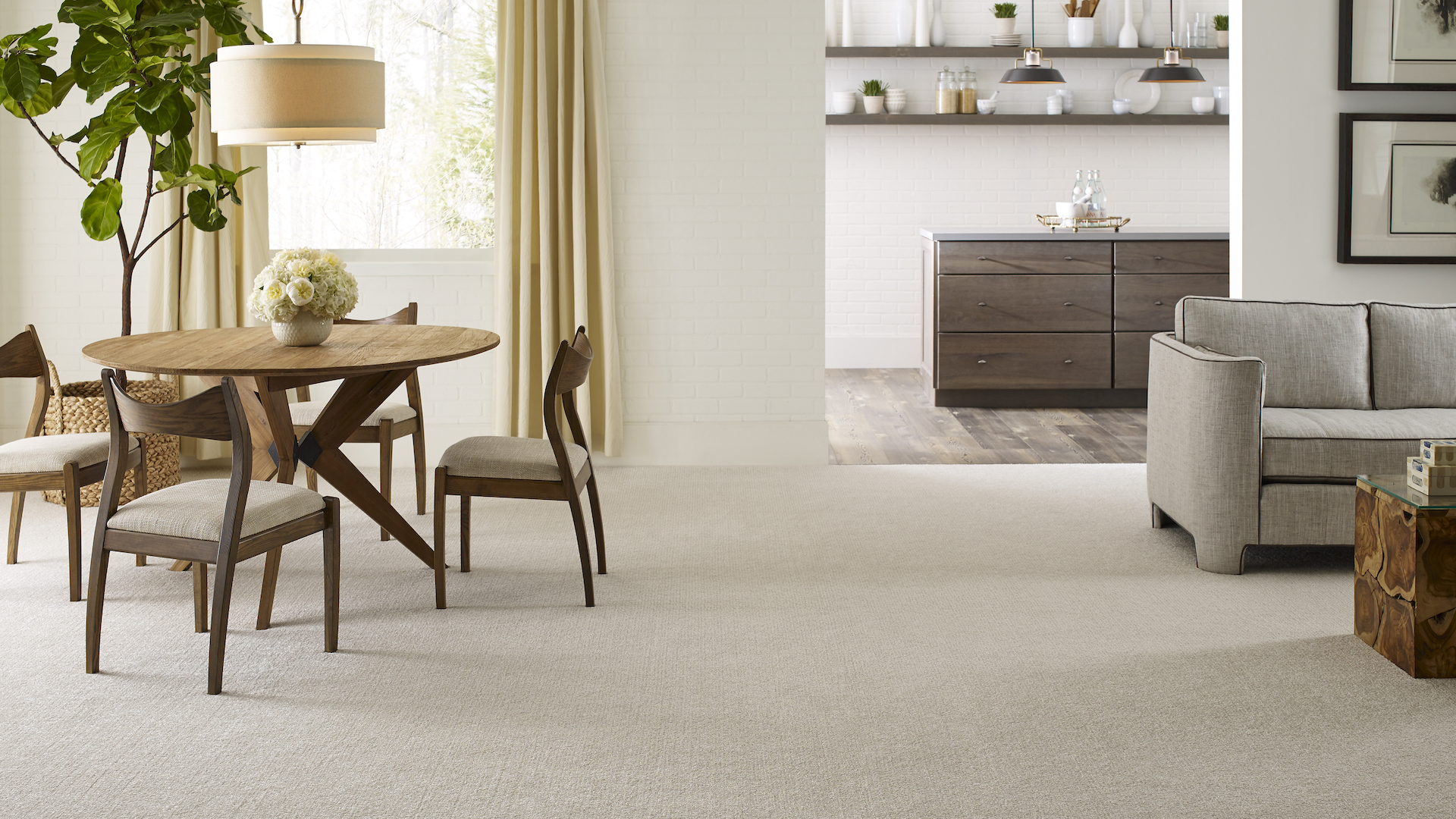 neutral beige carpets in a bright open-concept living and dining room